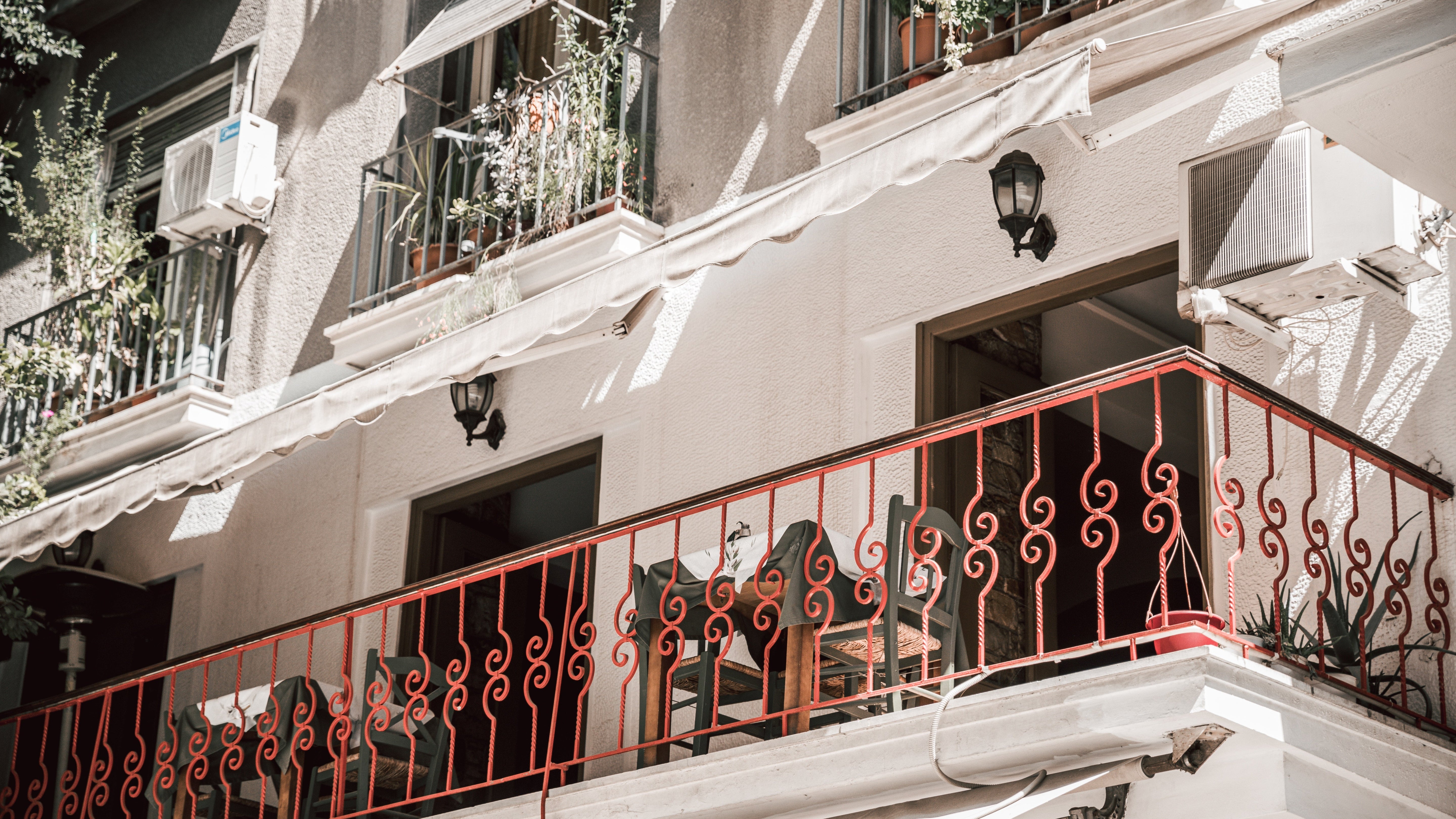 Balcony with red railing on a building facade