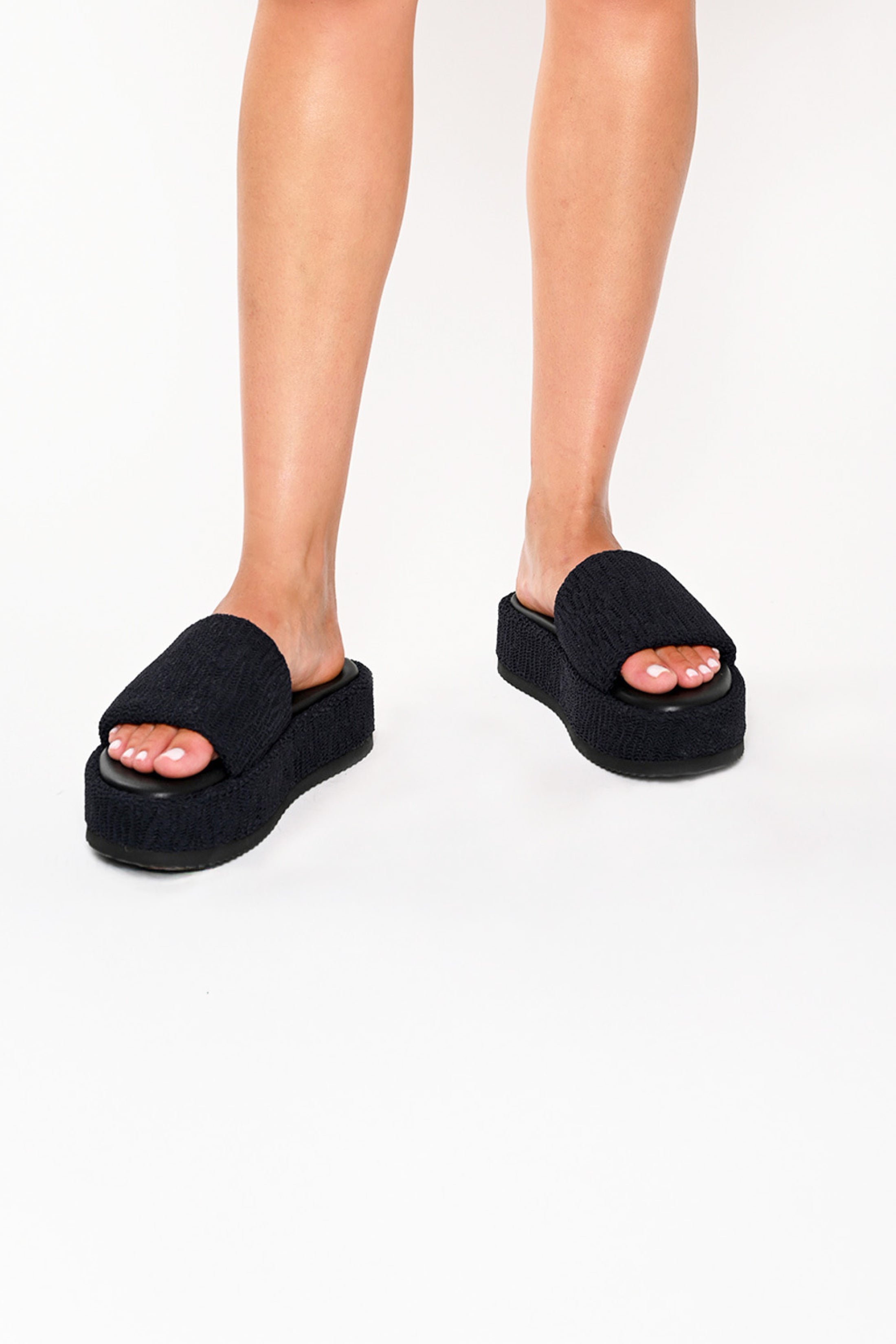 Model wearing Black platform slides