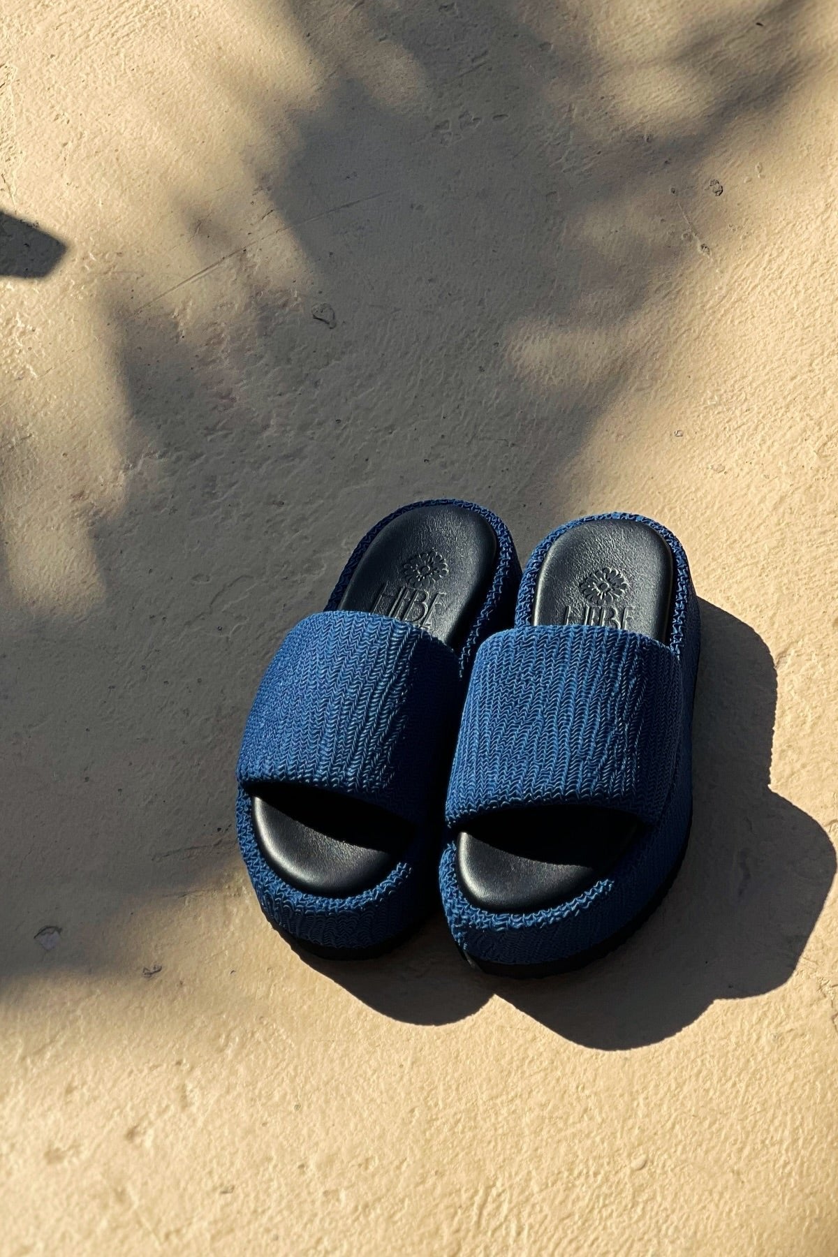 Pair of blue platform slides on a stone surface